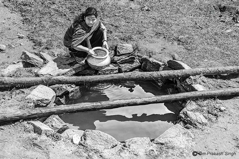 Procuring water from a traditional spring-based source in a Particularly Vulnerable Tribal Group (PVTG) hamlet in Gumla district, Jharkhand, India